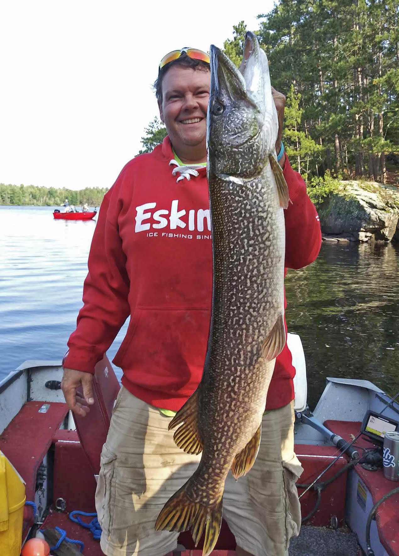 image of fisherman holding giant norther pike